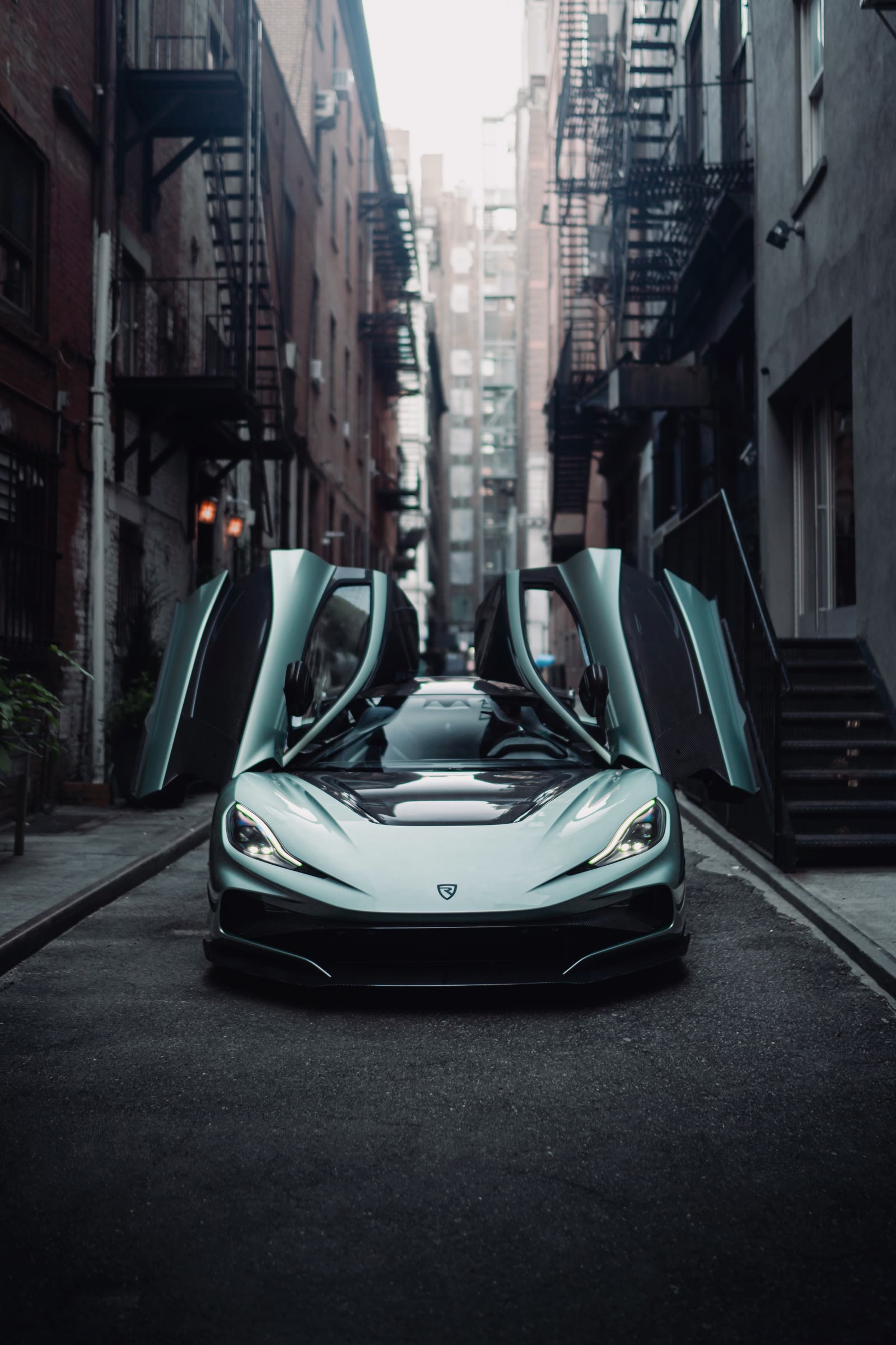 Rimac Nevera R with doors open in a downtown alley
